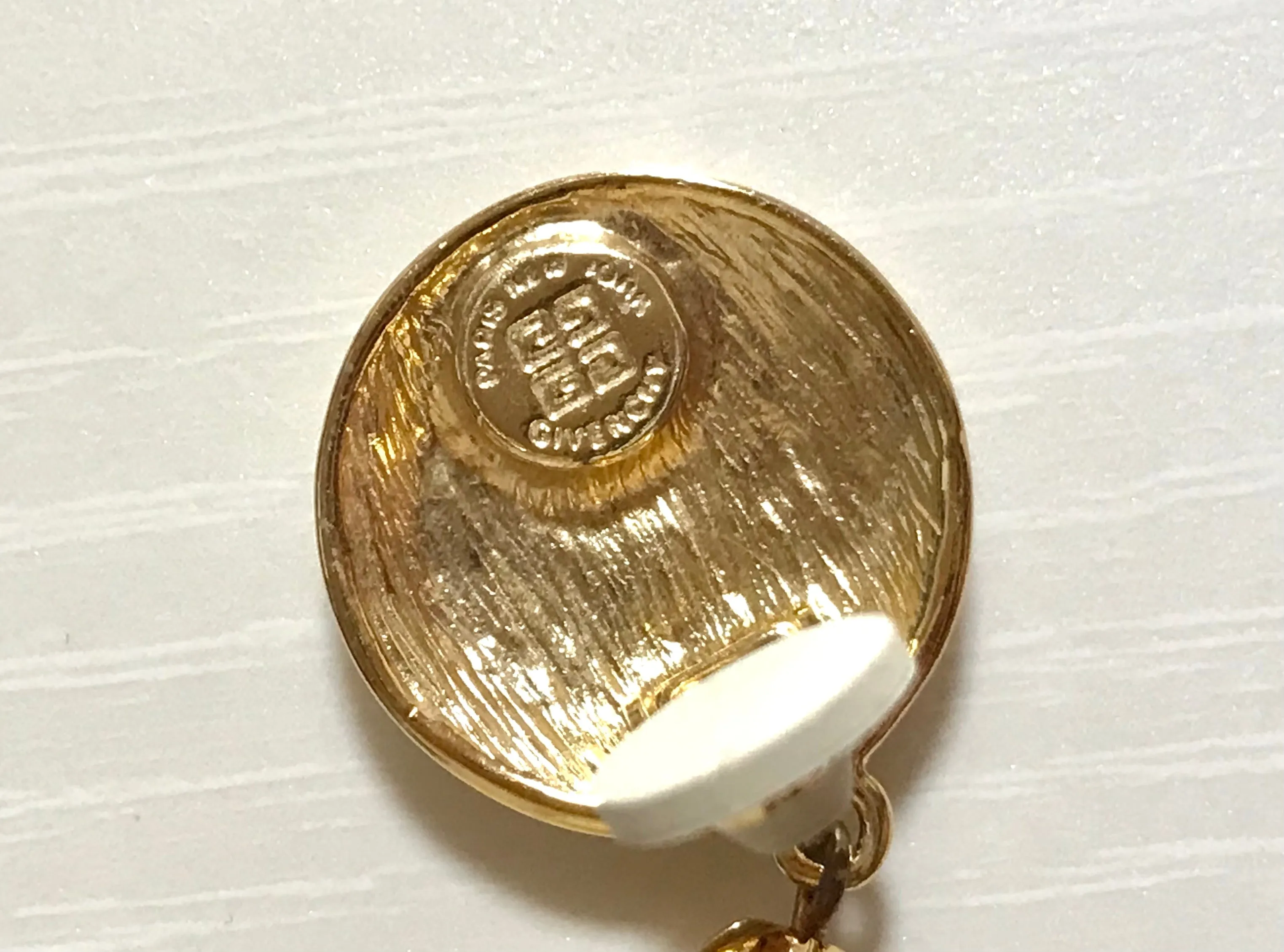 Vintage Givenchy golden round dangle earrings with teardrop faux pearl. Classic and beautiful jewelry piece.