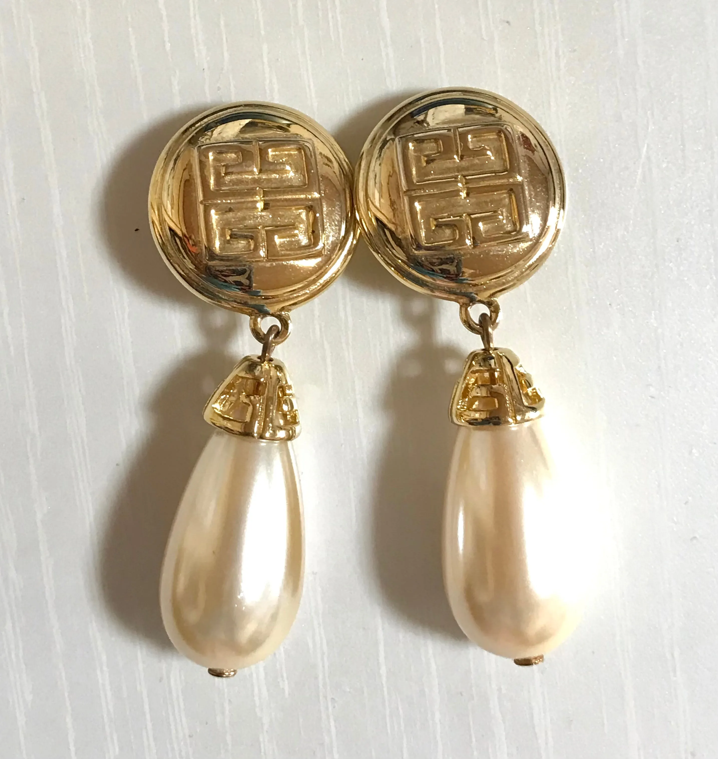 Vintage Givenchy golden round dangle earrings with teardrop faux pearl. Classic and beautiful jewelry piece.