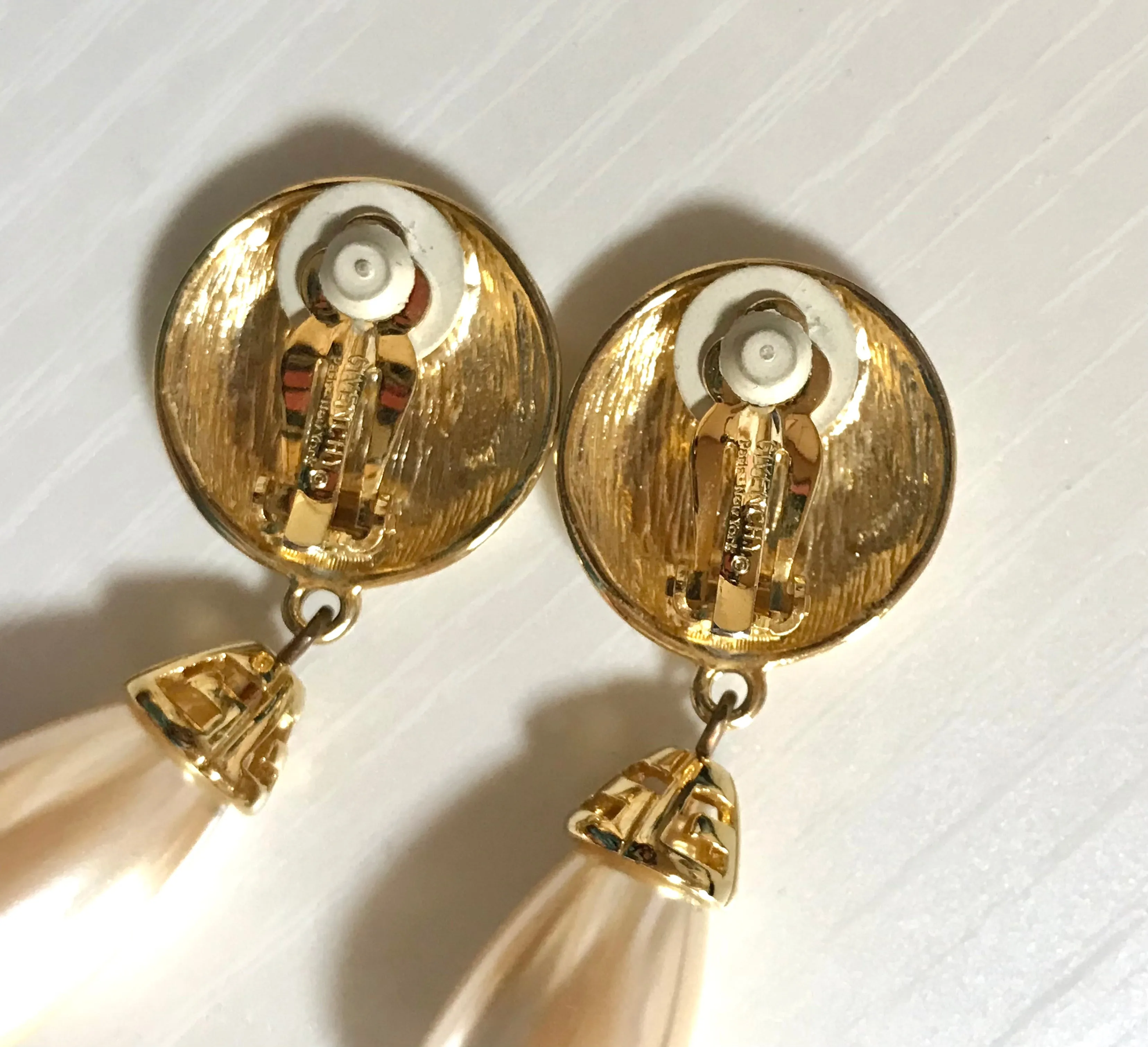 Vintage Givenchy golden round dangle earrings with teardrop faux pearl. Classic and beautiful jewelry piece.