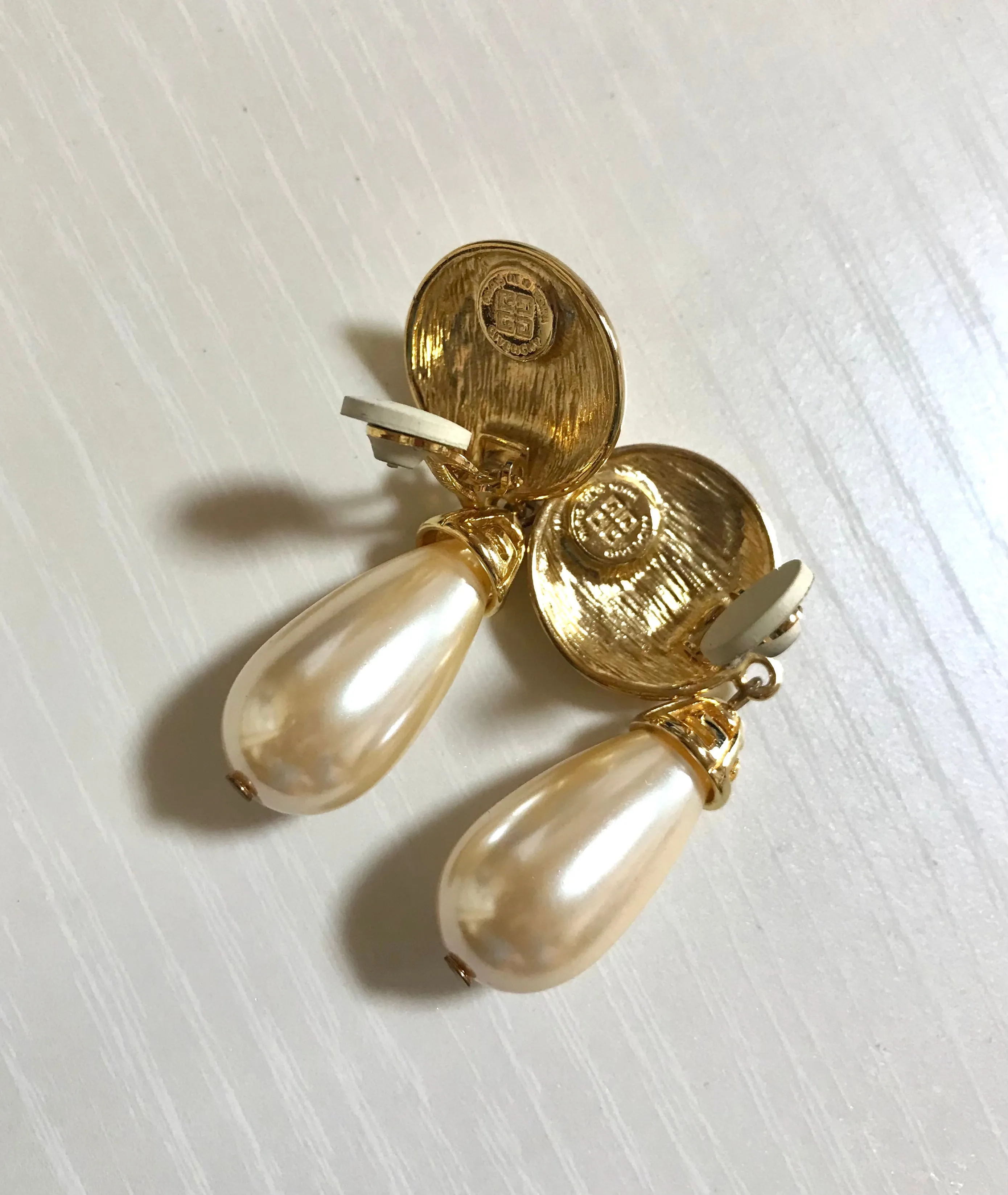 Vintage Givenchy golden round dangle earrings with teardrop faux pearl. Classic and beautiful jewelry piece.